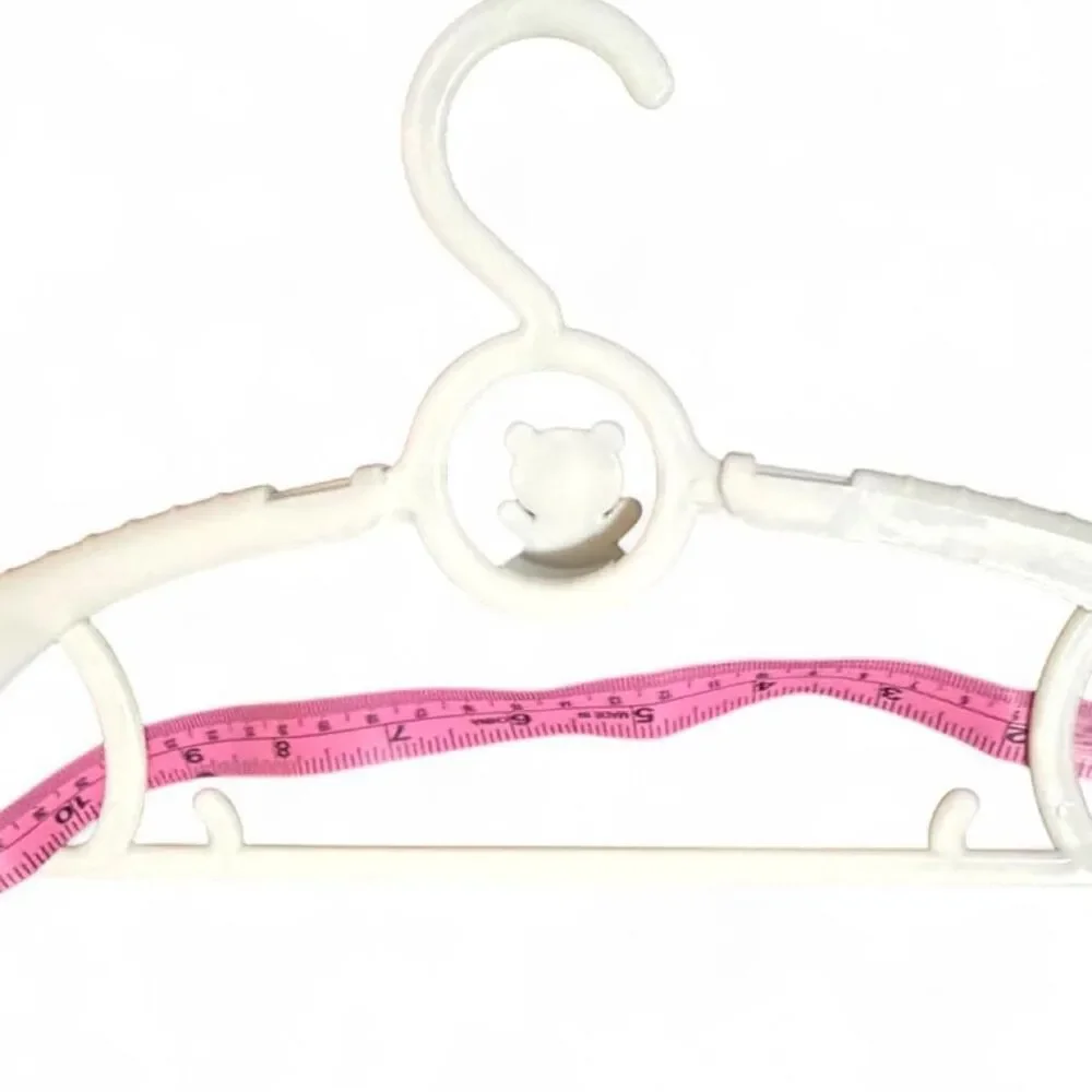 9 White plastic baby clothes hangers with bear design